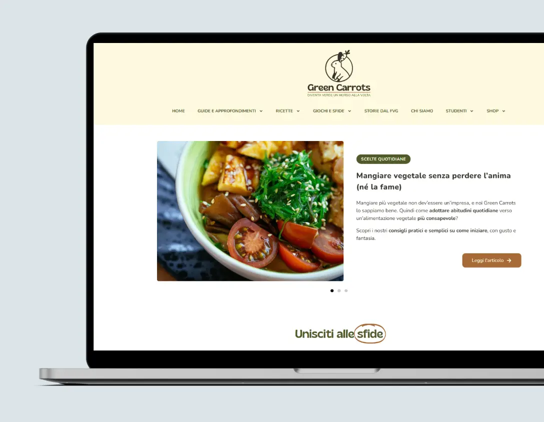Mockup di un laptop che mostra l‘anteprima della homepage del progetto di web design Green Carrots, inclusivo di header con logo e un articolo sull’alimentazione vegetale.