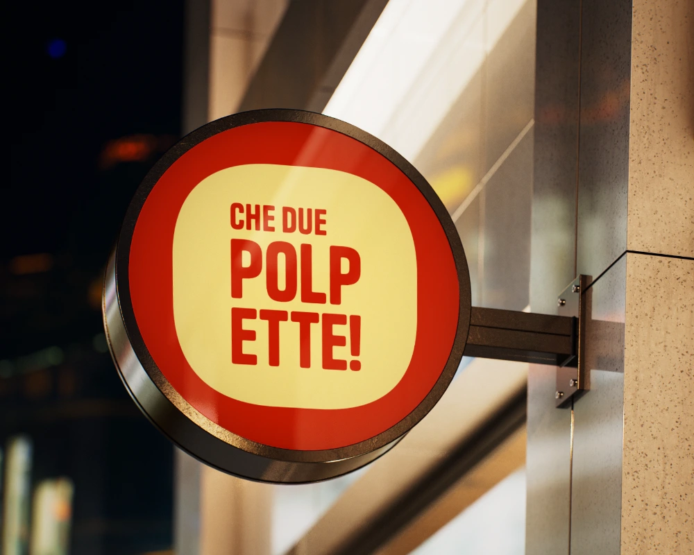 Mockup di un'insegna esterna rotonda che mostra l'applicazione del logo secondario e ridotto del brand nello spazio fisico.
